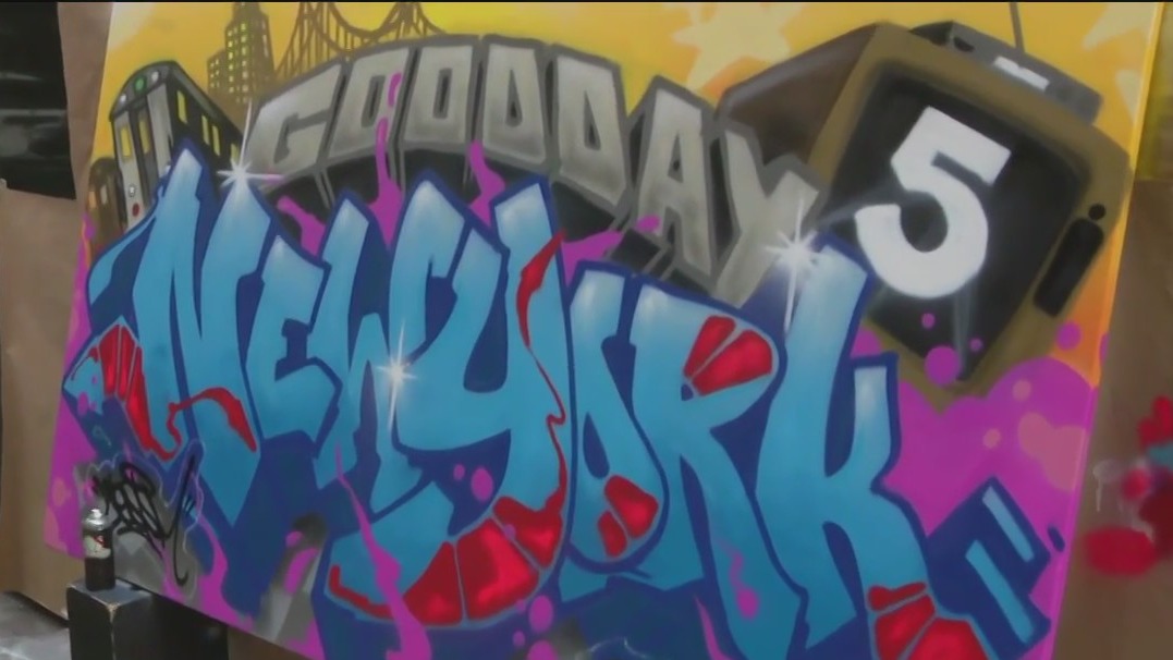 Graffiti artist makes mural outside GDNY studio