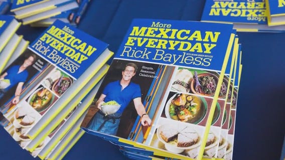 Rick Bayless signs cookbooks and gives out guacamole samples to fliers at O'Hare Airport