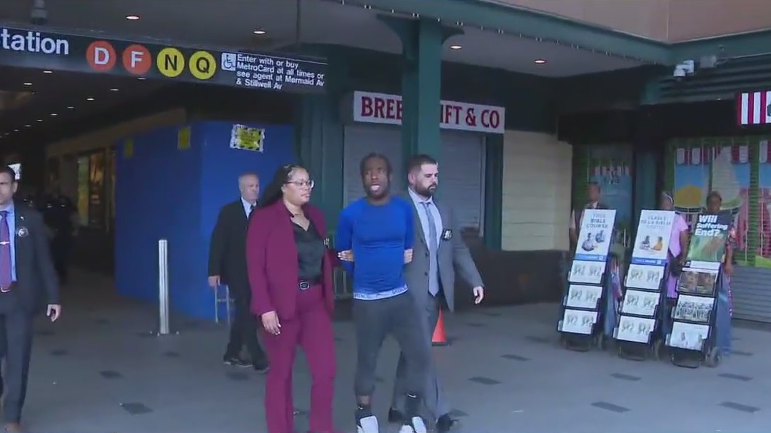 Man arrested after woman pushed onto subway tracks