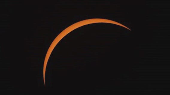 People gather along path of totality to see eclipse