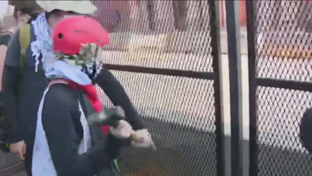 Demonstrators breach security perimeter outside of the United Center