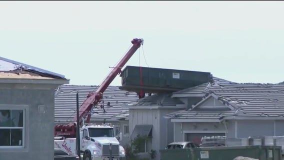 Hurricane Milton winds blow dumpster onto home's roof