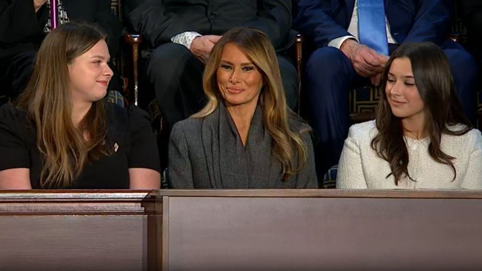 Melania Trump sits next to her guests during Trump's speech
