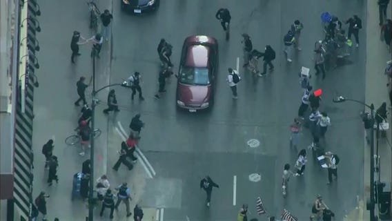 Video shows car driving through anti-ICE protesters in Chicago