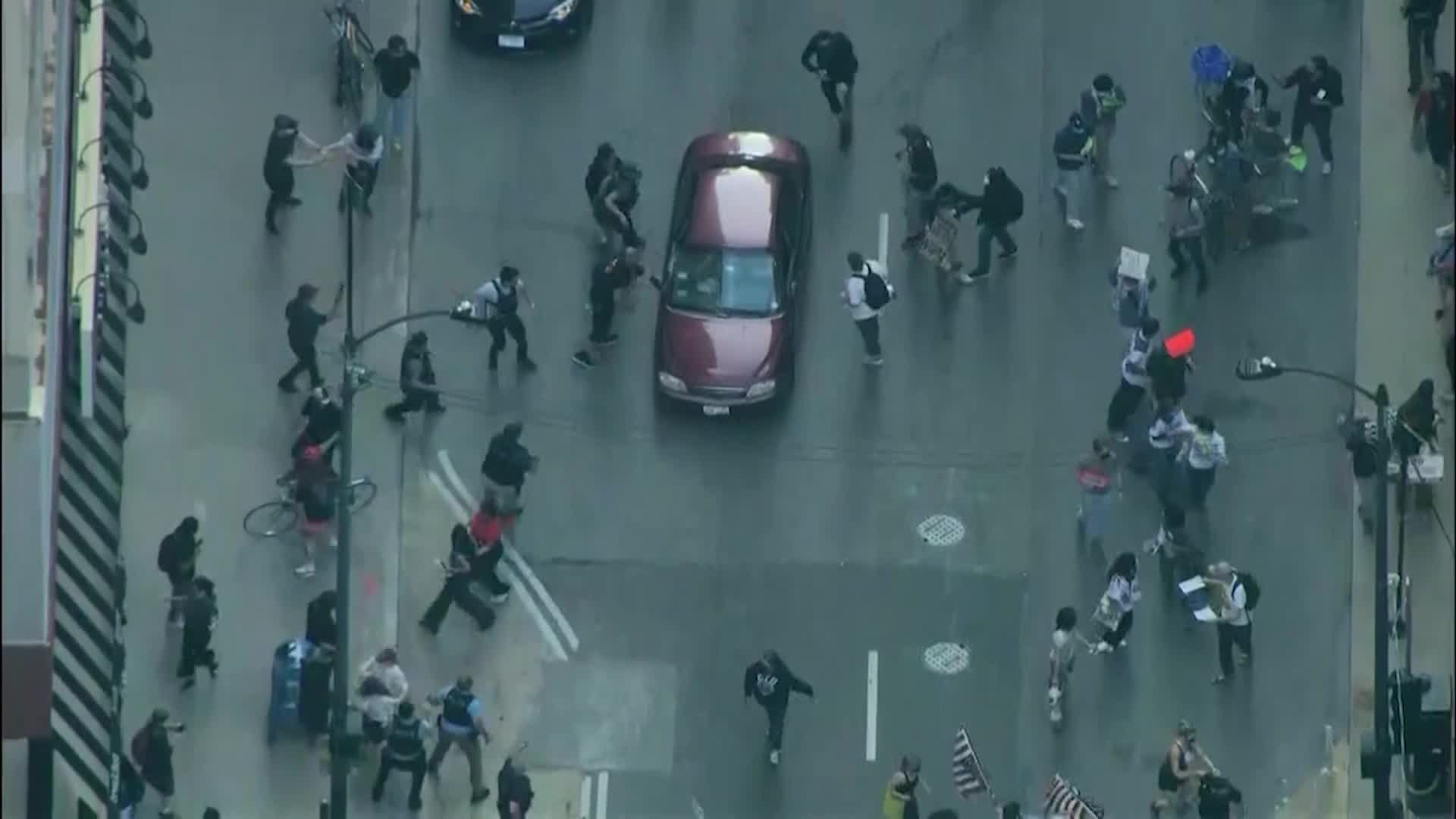 Video shows car driving through anti-ICE protesters in Chicago