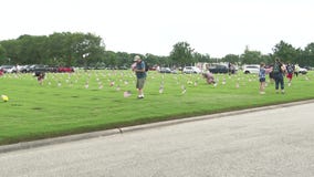 Residents place flags for fallen veterans on Memorial Day