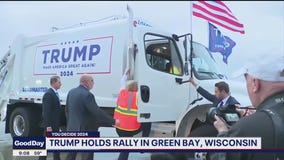 Trump shows up to rally in a trash truck