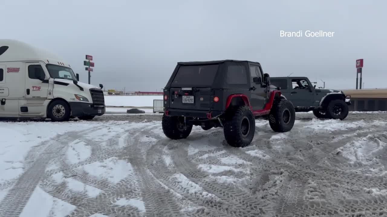 Jeep pulls semi out of snow