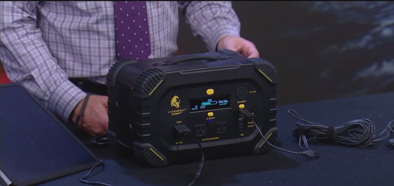 Meteorologist John Dawson demonstrating technology during bad weather