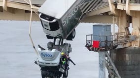 Truck driver saved from semi dangling off bridge
