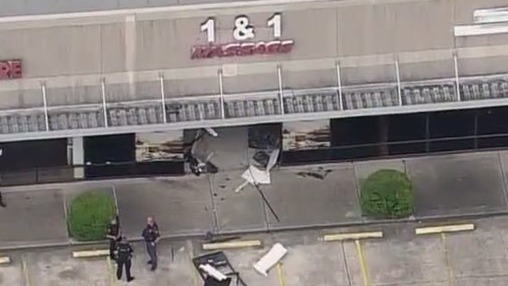 Vehicle drives into massage parlor