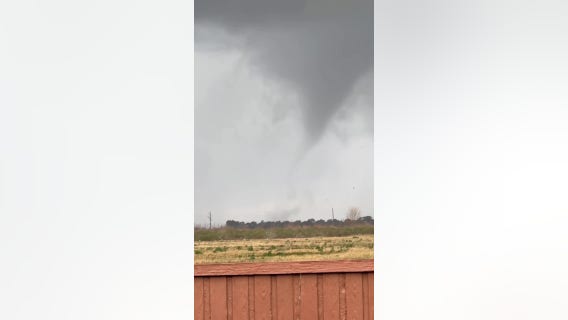 Funnel cloud, debris and lightning near Katy