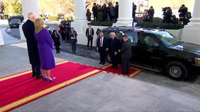 Bidens greet Trumps at White House