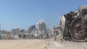 Israel strikes Gaza high-rise; Hamas shows video of hostages