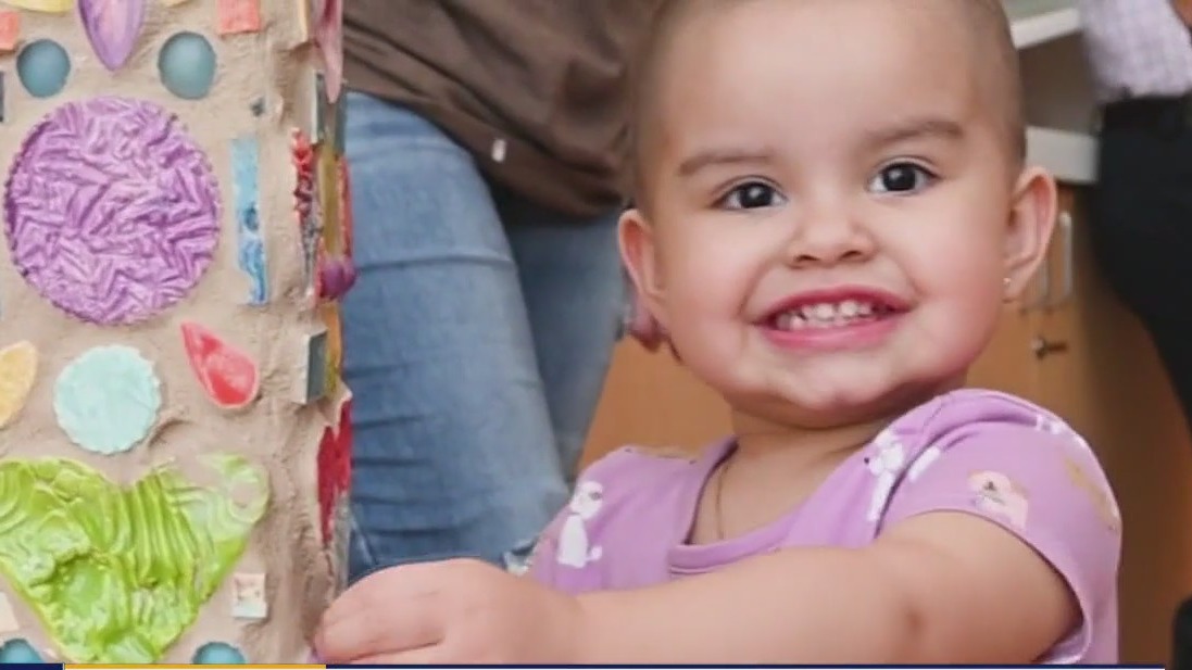Child cancer patients ring bell celebrating being cancer free