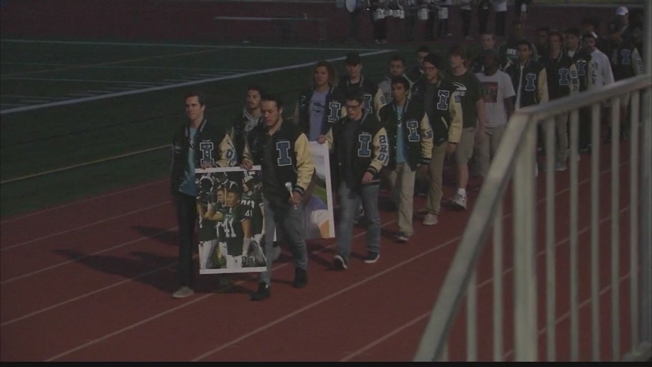 Former Irvine football player honored at candlelight vigil