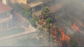 Fast moving brush fire scorches Burbank hillside, homes threatened