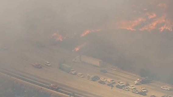 Brush fire in Sun Valley closes 210 freeway with flames and high winds