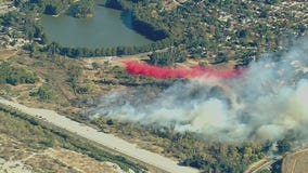 Fast spreading brush fire erupts along Riverside park