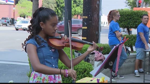 Young violinist plays in public to pay for music lessons