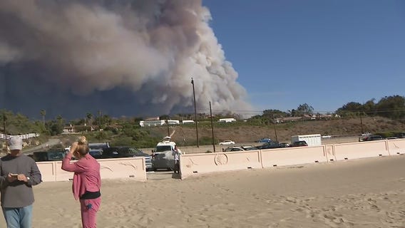 Large plume of smoke hangs over Zuma Beach from brush fires