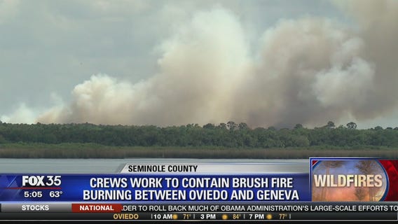 Crews work to contain brush fire burning between Oviedo and Geneva