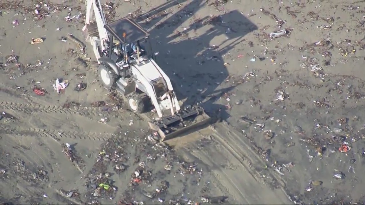 Trash lines shore following rain storms in Seal Beach