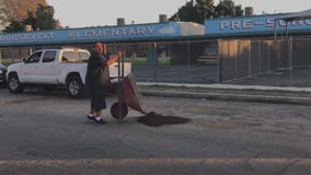 Compton family pitches in to repair potholes on street