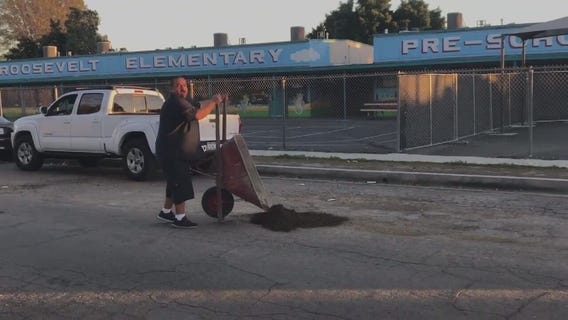 Compton family pitches in to repair potholes on street