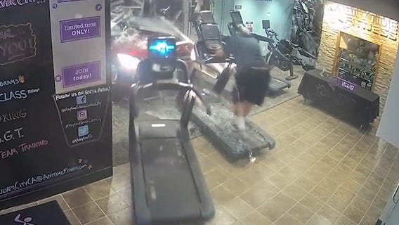 Car crashes through gym pinning man between treadmill and wall