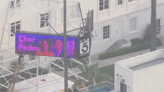 Man with sign climbs TV tower in Hollywood