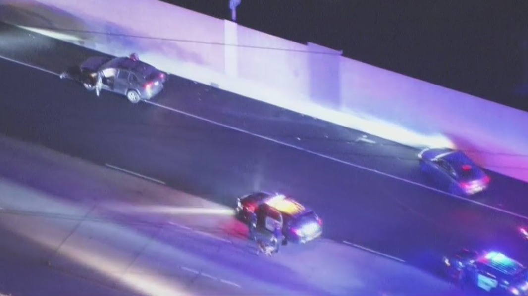 Chase suspect drives with hood flipped up