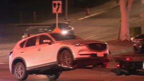 Driver accused of ramming police officers shot by cops