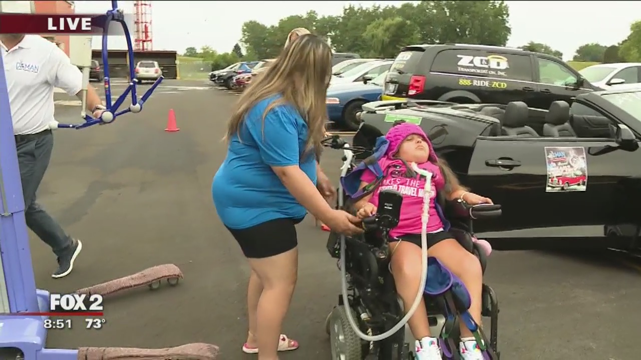 D-MAN giving convertible rides to those in wheelchairs at Dream Cruise