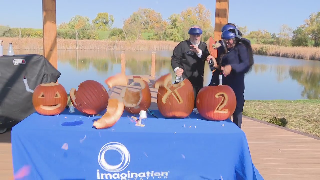 Ryan ducks behind Maurielle while making Self-Carving pumpkins