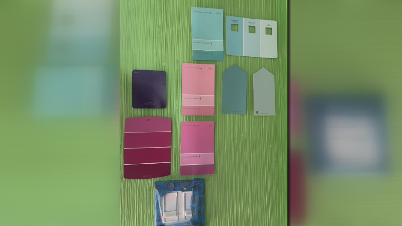 Maurielle gets a painting lesson from Creative Colors Owner, Wayne Riedy