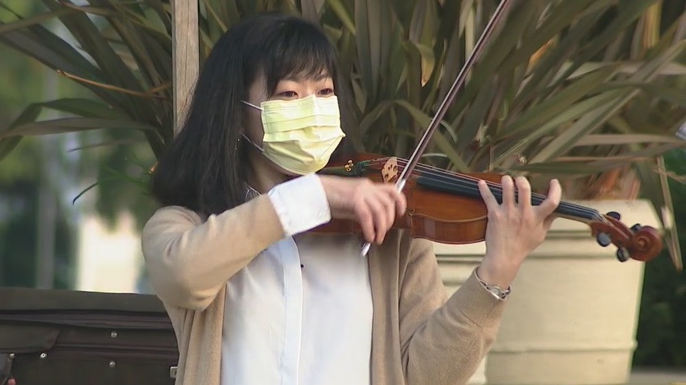 Neighbors stop to catch woman play violin in West LA