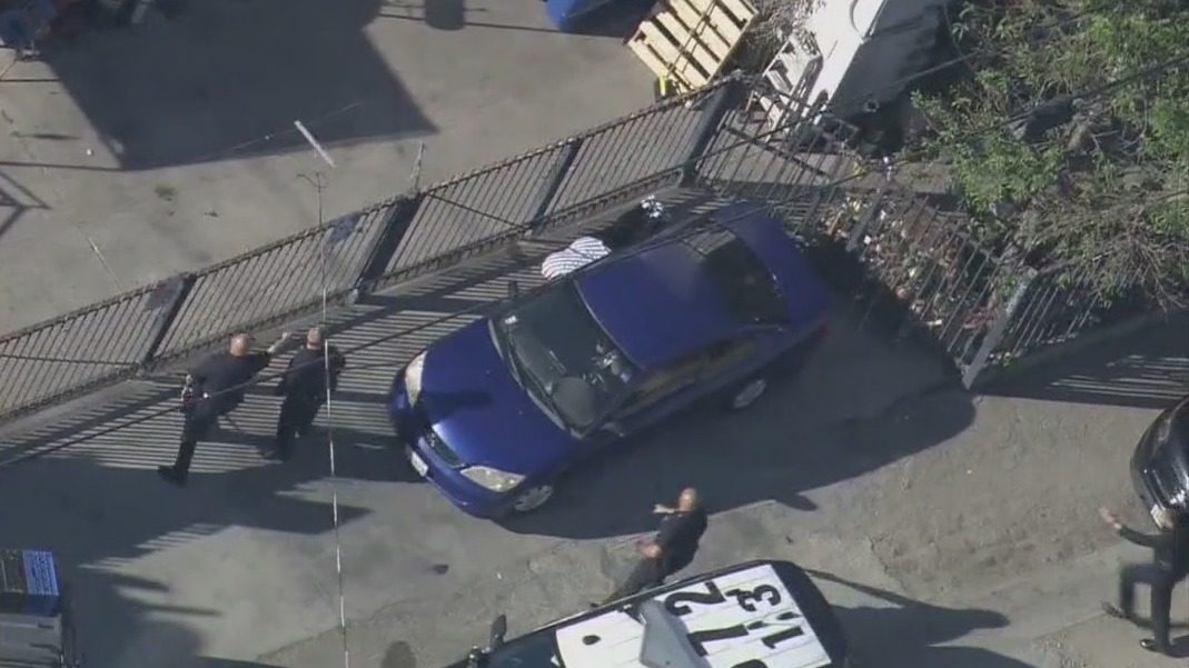 Video of man laying next to car trying to hide from LAPD goes viral