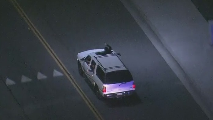 LA Police Chase: Passenger pokes head out SUV mid-pursuit