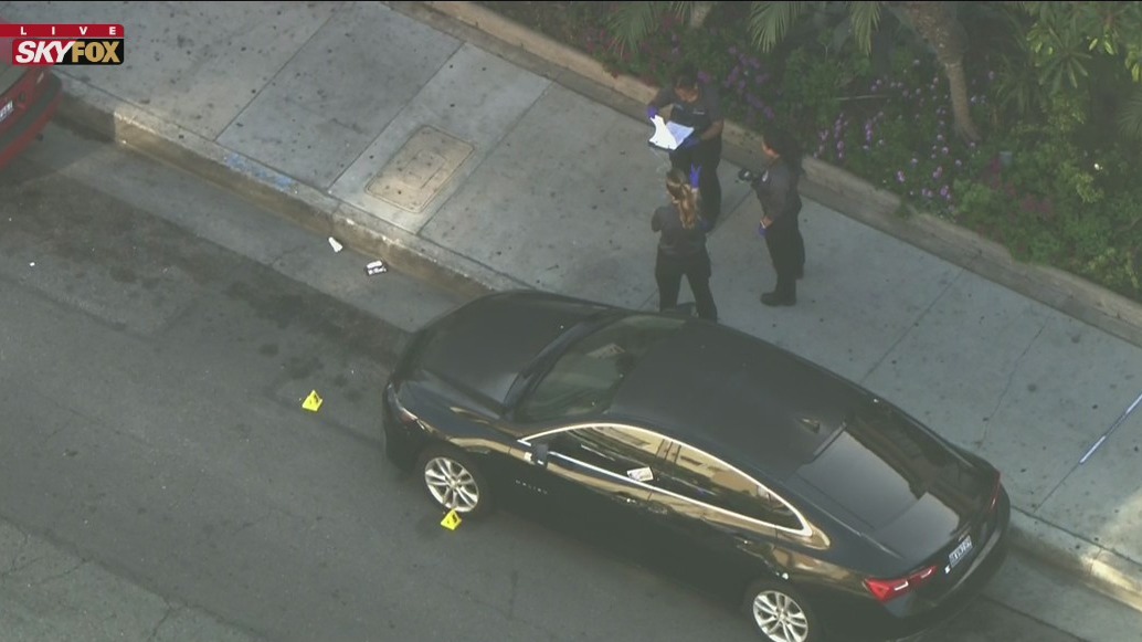 Possible drive-by shooter opens fire on pedestrians on sidewalk; 2 shot