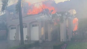 Coastal Fire: Roof collapses, loud bangs heard outside several burning OC mansions