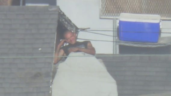 VIDEO: Man tries to evade authorities by 'hiding' on roof in South LA