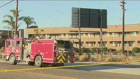 Armed suspect barricaded inside Commerce hotel