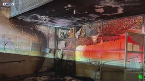 Woman accused of pushing burning shopping car to LAPD station