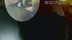 Cop punches mom holding baby in her arms