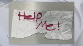 Kinapped girl holds 'Help Me' sign to passerbys