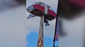 Carnival worker clings to ride to protect child after mishap