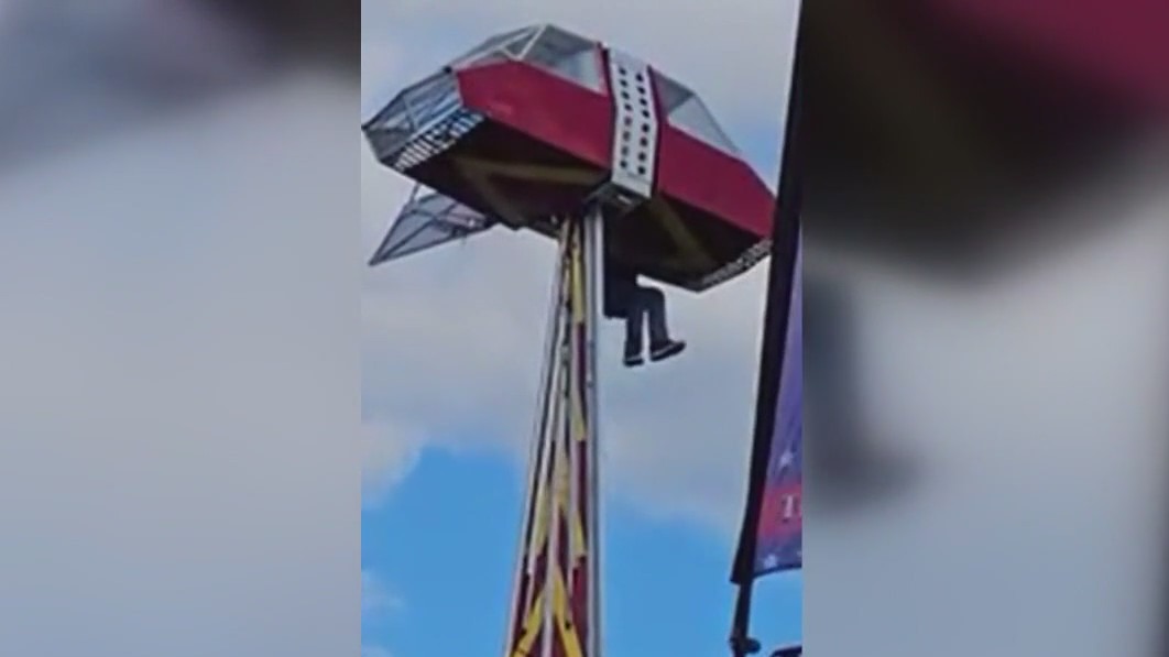 Carnival worker clings to ride to protect child after mishap