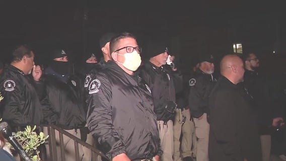 Private security standing still amidst chaos