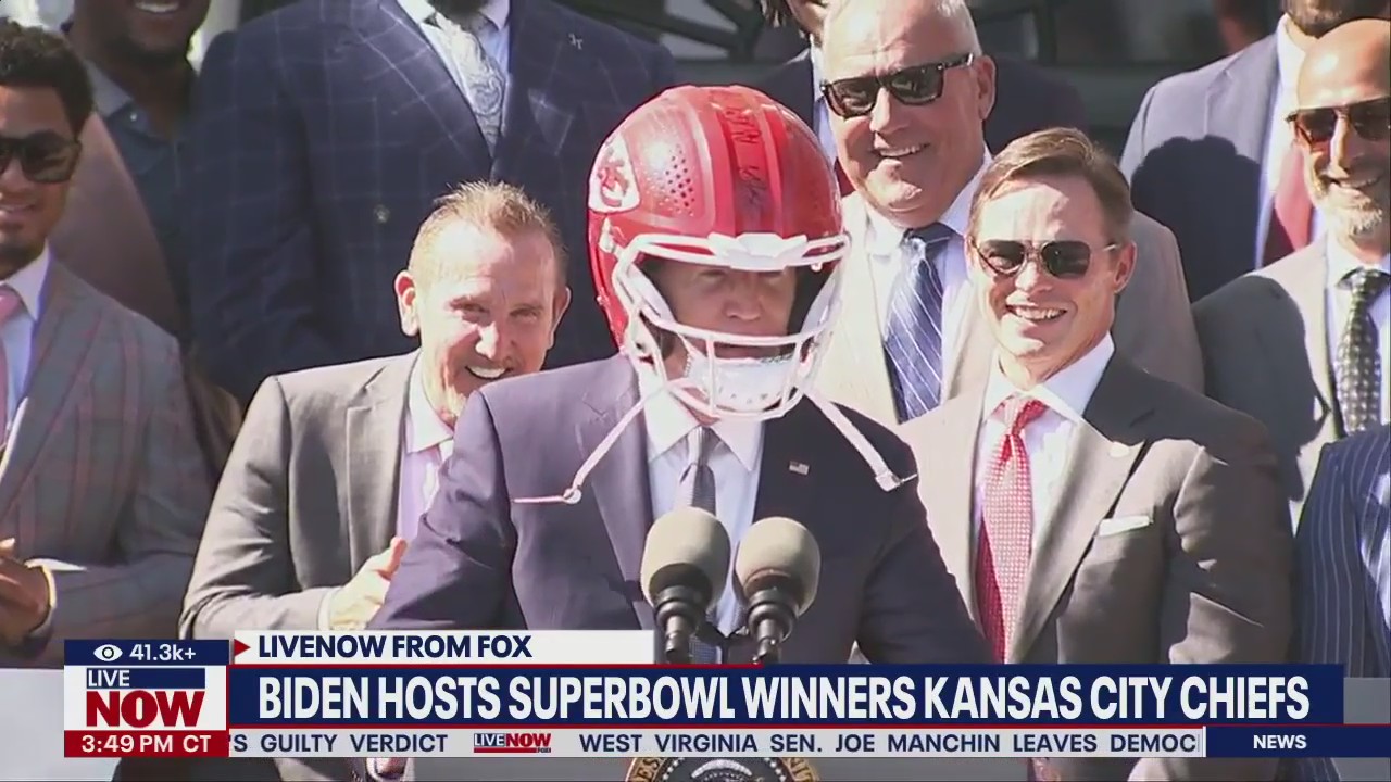 President Joe Biden puts on Chiefs helmet at Super Bowl celebration